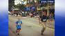 Lance Cpl. Myles Kerr with a 9-year-old boy running a race