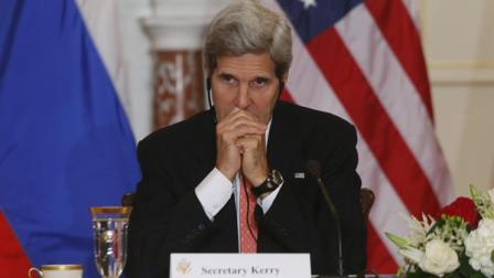 Secretary of State John Kerry listens to translation as he meets with Russian Foreign and Defense ministers at the State Department in Washington