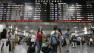 Travelers make their way to their trains inside Penn Station in New York.