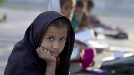 Pakistani student Farah Muneeb from Islamabads slums sits with fellow students at a makeshift school set up by a volunteer in a park in Islamabad, Pakistan on Thursday, Oct 11, 2012.