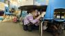 Jaely John, 7, a student at Twin Lakes Elementary School in Federal Way, Wash., takes shelter under a table as she takes part in an earthquake drill, Thursday, Oct. 18, 2012.
