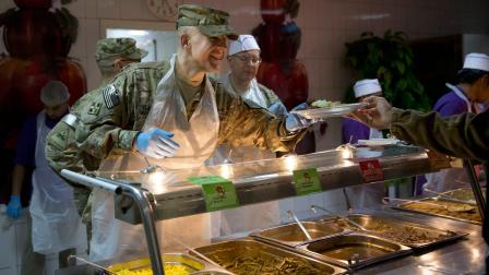 A U.S. Army officer serves Thanksgiving dinner to a comrade at a dining facility at his base in Kabul, Afghanistan, Thursday, Nov. 28, 2013. Its the 12th Thanksgiving in Afghanistan for U.S. troops. (AP Photo/Anja Niedringhaus)