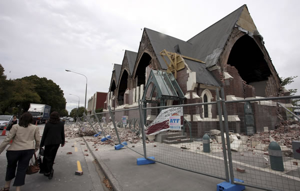 People walk past a church in Christchurch, New...