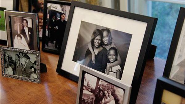 Family photos are displayed in the Oval Office behind President Obama's desk, Tuesday, Aug. 31, 2010, at the White House in Washington.