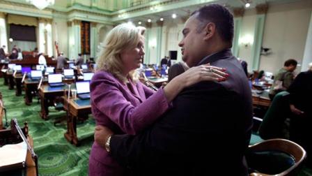 Assemblywoman Cathleen Galgiani, D-Livingston, left, hugs Assembly Speaker John Perez, D-Los Angeles, after an all night session ended at the Capitol in Sacramento, Calif., Friday, Oct. 8, 2010.