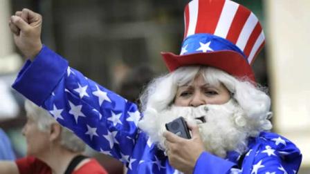 Magda Castaneda, who opposes the Tea Party, yells during a Tea Party rally at the Daley Plaza Thursday, April 15, 2010, in Chicago. (AP Photo/Paul Beaty)