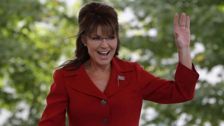 Former vice presidential candidate and Alaska Gov. Sarah Palin waves to supporters before addressing a Tea Partly Express Rally in Manchester, N.H.