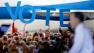 Crowd members hold up a sign reading vote as Republican presidential candidate, former Massachusetts Gov. Mitt Romney speaks during a campaign event at the Orlando Sanford International Airport, Monday, Nov. 5, 2012, in Sanford, Fla.