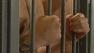 Prisoners behind bars.