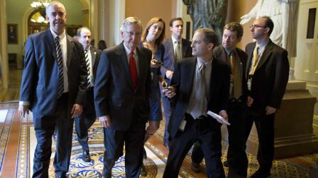 Senate Minority Leader Mitch McConnell of Ky., is pursued by reporters after returning to Capitol Hill in Washington, Friday, Oct. 11, 2013