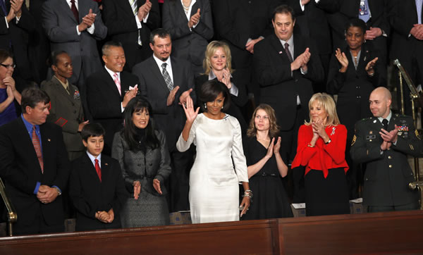 First lady Michelle Obama waves on Capitol Hill in Washington, Tuesday, Jan. 25, 2011, prior to the start of President Barack Obama's State of the Union address. (AP Photo/Evan Vucci)