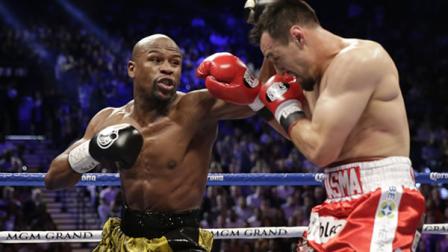 Floyd Mayweather Jr. and Robert Guerrero exchange punches. (AP Photo/Isaac Brekken)