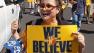 Warriors fan holds a We Believe sign