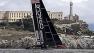 Oracle Team USA goes past Alcatraz Island before the start of the first running of the 13th race of the Americas Cup sailing event against Emirates Team New Zealand, Friday, Sept. 20, 2013, in San Francisco