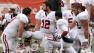 Stanford quarterback Andrew Luck (12) kneels on the field with teammates as injured Stanford receiver Chris Owusu is tended to during the first half of their NCAA college football game