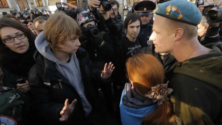 A gay rights activist, left, argues with anti-gay protesters during an authorized gay rights rally in St.Petersburg, Russia
