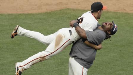 San Francisco Giants Jonathan Sanchez (57) is greeted by in the dugout by Andres Torres and his teammates after scoring the Giants first run in the third inning of their baseball game against the San Diego Padres in San Francisco, Sunday, Oct. 3, 2010. Sanchez scored from third base after the Giants Freddy Sanchez singled. (AP Photo/Eric Risberg)