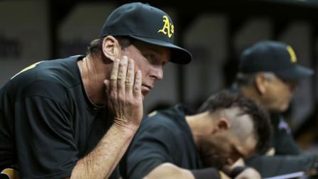 Oakland Athletics manager Bob Melvin, left, and Jonny Gomes react during the first inning of a baseball game against the Tampa Bay Rays, Friday, May 4, 2012, in St. Petersburg, Fla. (AP Photo/Chris OMeara)