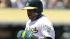 Oakland Athletics Yoenis Cespedes, left, scores past Kansas City Royals catcher George Kottaras in the fourth inning