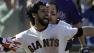 San Francisco Giants Angel Pagan, center foreground, celebrates with Andres Torres after hitting an inside-the-park two-run home run off Colorado Rockies pitcher Rafael Betancourt
