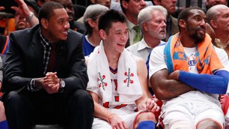 New York Knicks Jeremy Lin, center, talks with teammates Carmelo Anthony, left, and Amare Stoudemire, right, during the second half of an NBA basketball game against the Sacramento Kings, Wednesday, Feb. 15, 2012, in New York.