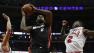 Miami Heat small forward LeBron James (6) heads to the hoop against Chicago Bulls point guard Nate Robinson (2) and Chicago Bulls shooting guard Marco Belinelli (8)