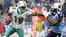 FILE - In this Dec. 20, 2009, file photo, Miami Dolphins wide receiver Ted Ginn Jr. (19) tries to fend off Tennessee Titans Lavelle Hawkins (87)