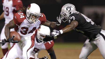 Arizona Cardinals running back Ryan Williams (34) runs from Oakland Raiders defensive back Zac Etheridge (43) in the second half of an NFL preseason football game in Oakland, Calif.