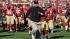 San Francisco 49ers coach Jim Harbaugh runs off...