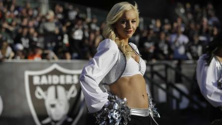 An Oakland Raiders cheerleader performs during the second half of an NFL football game against the Denver Broncos in Oakland, Calif., Sunday, Dec. 29, 2013.
