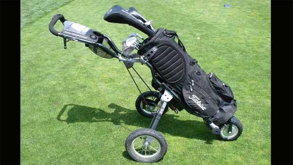 Can a golfer maintain self-respect AND use a wheeled apparatus?
