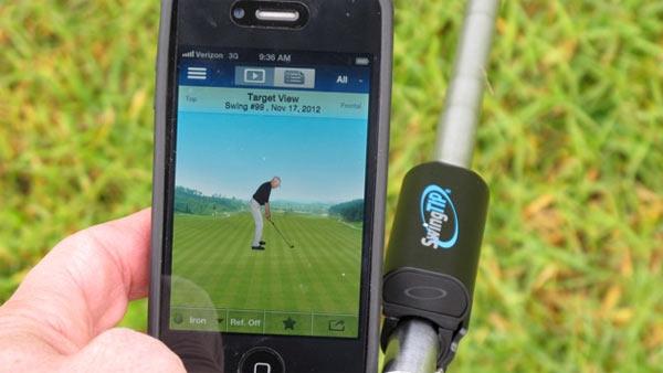 The SwingTip Ap on a smartphone, next to the sensor.