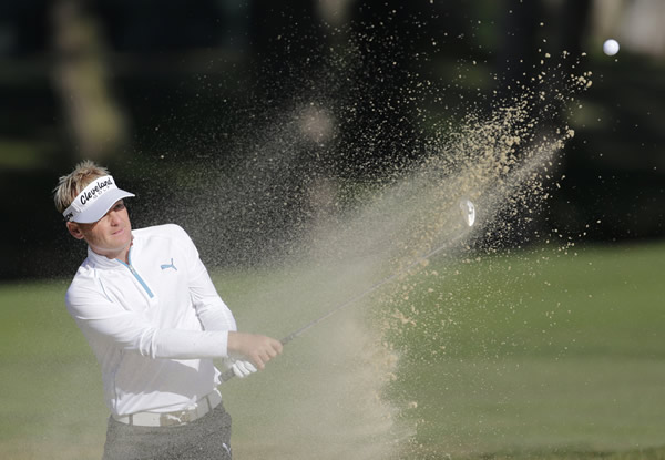 Soren Kjeldsen, of Denmark, hits out of a bunker...