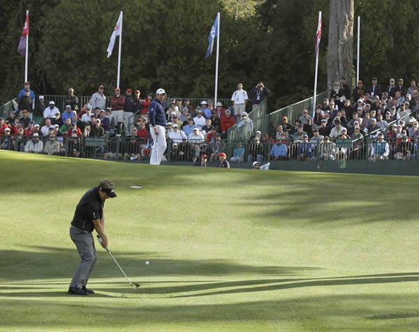 Luke Donald, of England, hits a shot on the 17th...