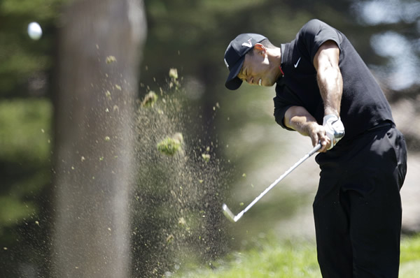 Tiger Woods hits a drive on the third hole...