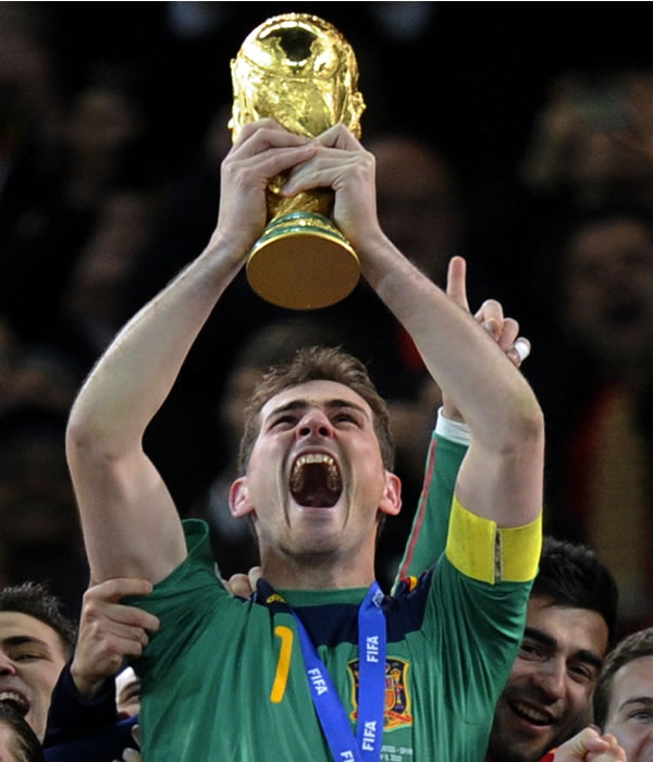 Spain goalkeeper Iker Casillas holds up the...