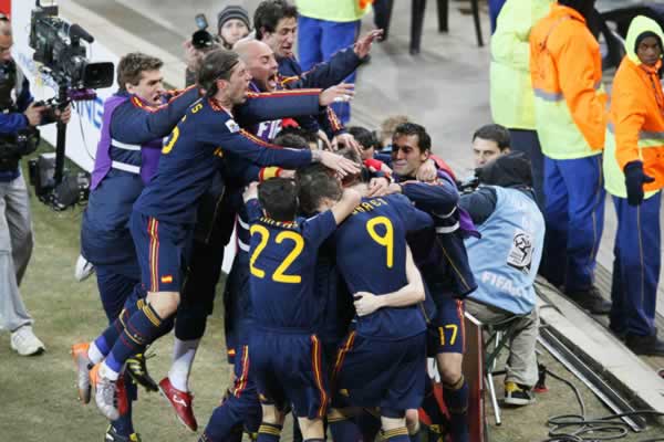 Spain players react after a 1-0 victory over the Netherlands during the final soccer match of the World Cup at Soccer City stadium in Johannesburg, South Africa, Sunday, July 11, 2010, to win its first World Cup title. (AP Photo/Eugene Hoshiko)