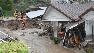 Firefighters examine a flood-damaged home near Ocean View Boulevard.