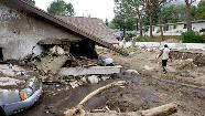 Henry Laguna walks around his property after a mudslide caused by heavy rains damaged his house in La Canada Flintridge, California.