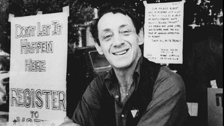 Harvey Milk poses in front of his camera shop in San Francisco in this Nov. 9, 1977 photo.
