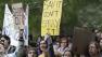 Demonstrators hold signs during a rally on the University of California, Davis campus in Davis, Calif., Monday, Nov. 21, 2011 after police pepper-sprayed peaceful demonstrators during an anti-Wall Street protest at the same spot on Friday.