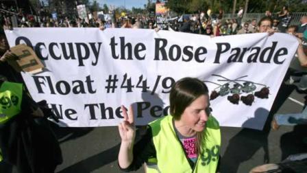 Occupy protesters march along Colorado Boulevard during the 123rd Tournament of Roses Parade in Pasadena, Calif., Monday, Jan. 2, 2012.