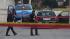 Law enforcement officers look over the scene of...