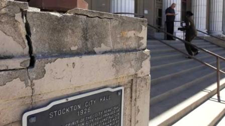 A light standard rests at the dilapidated entrance to city hall Tuesday, June 26, 2012, in Stockton, Calif.