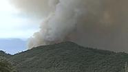 A wind-whipped wildfire near the main route into Yosemite forced the evacuation of about 150 houses and threatened others.