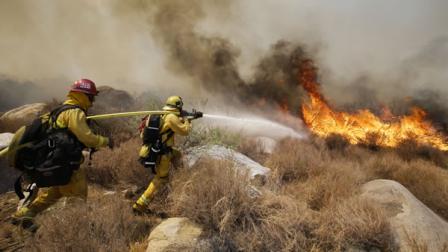 Firefighters battle a wildfire on Thursday, Aug. 8, 2013, in Cabazon, Calif.