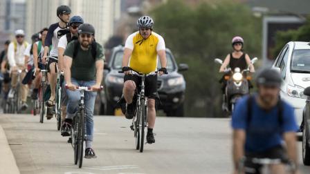 In this Tuesday, June 11, 2013 photo, cyclists ride on Milwaukee Avenue in Chicago