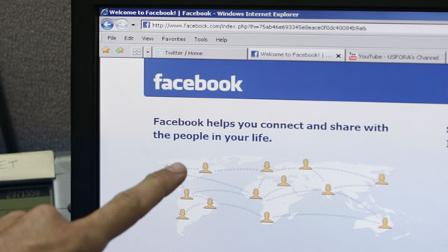 A man points to the Facebook website.