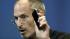 Apple CEO Steve Jobs holds up iPhone 4 as he...