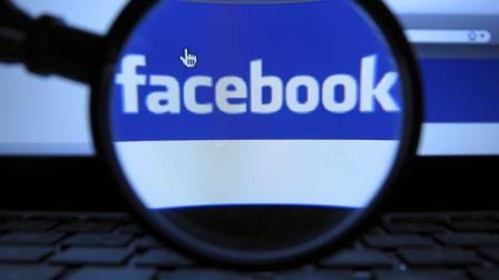 This Oct. 11, 2010 file photo, shows the logo of the online network Facebook, recorded in Munich with a magnifying glass of a computer screen of a laptop. (AP Photo/dapd, Joerg Koch)